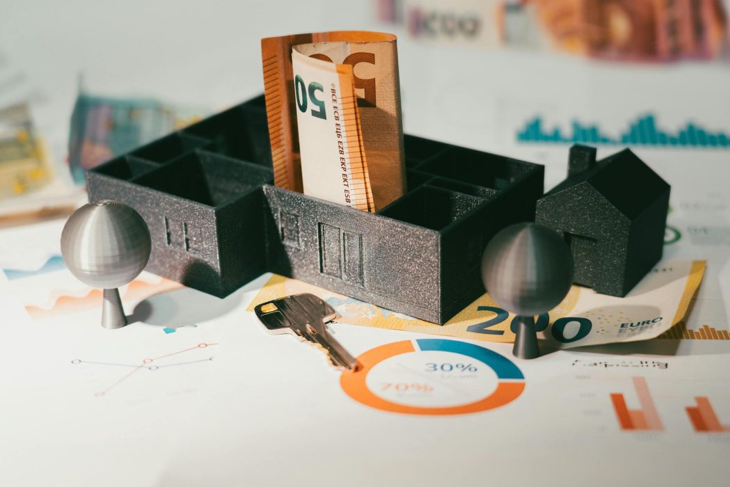 real estate finance house model table money banknotes door key