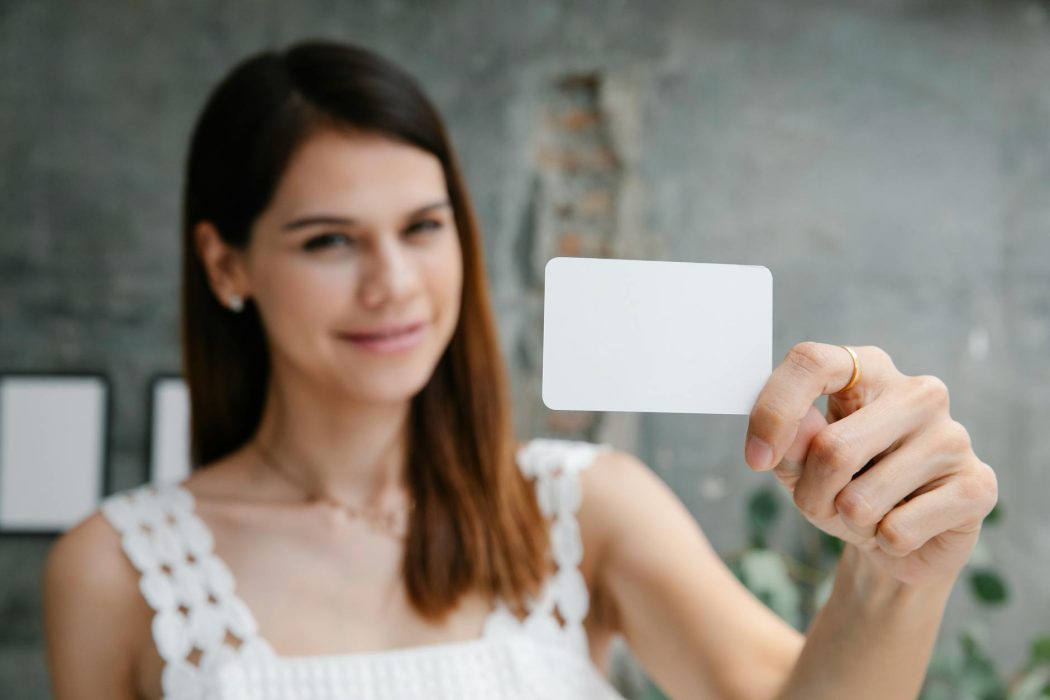 woman holding blank card