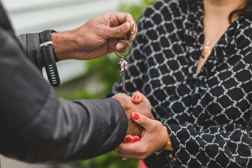 person holding a silver key