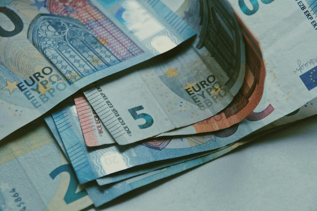 close up shot of euros on white surface